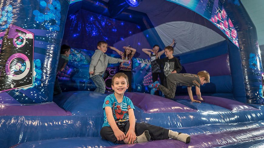 Children at a bouncy castle party at the DMU leisure centre