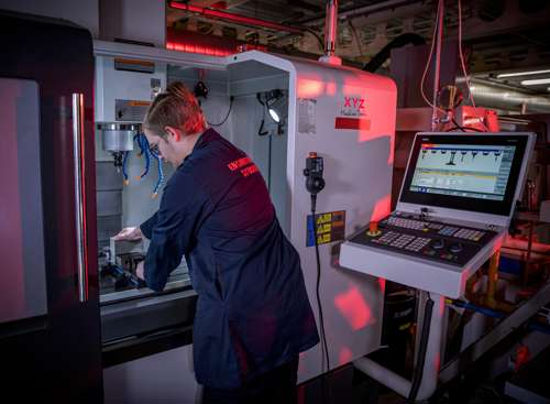 Student using a CNC machine