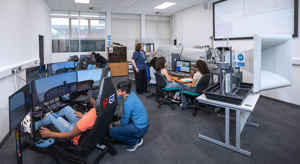 Students using flight simulation equipment